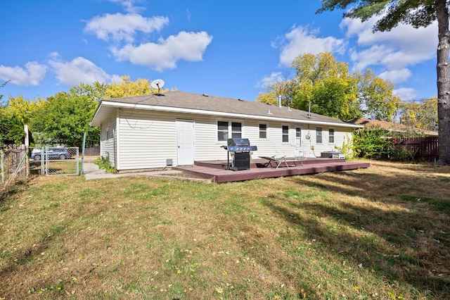 back of house featuring a deck and a yard