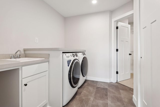 laundry area with washing machine and dryer and sink