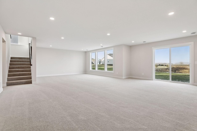 unfurnished living room with light colored carpet