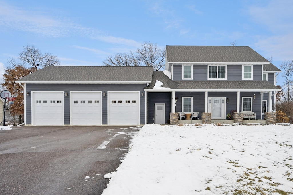 view of front of house featuring covered porch and a garage