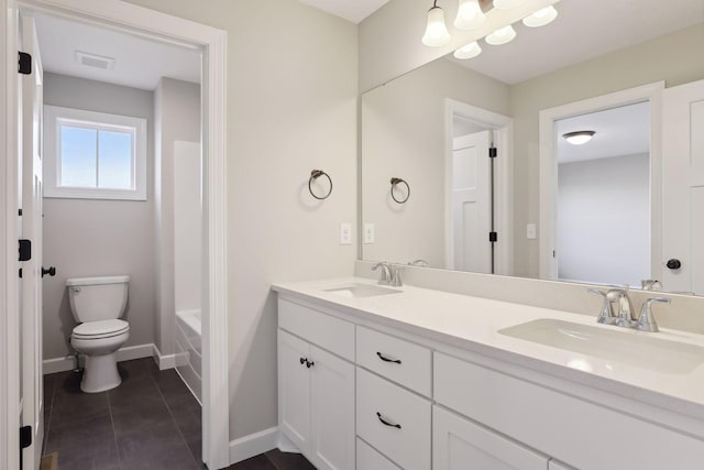 bathroom with tile patterned floors, vanity, and toilet