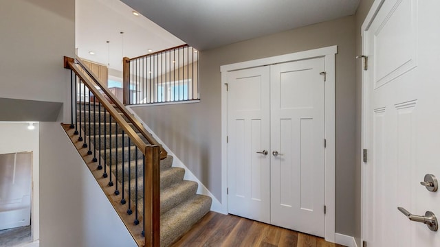 stairs featuring hardwood / wood-style floors