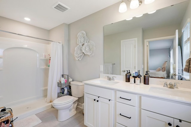 bathroom featuring vanity, curtained shower, and toilet