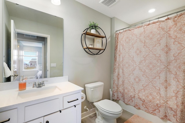 full bathroom featuring vanity, shower / tub combo with curtain, and toilet