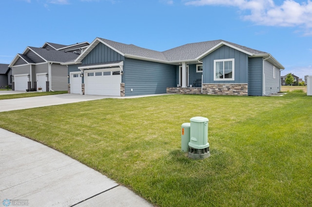 craftsman house with a front yard and a garage