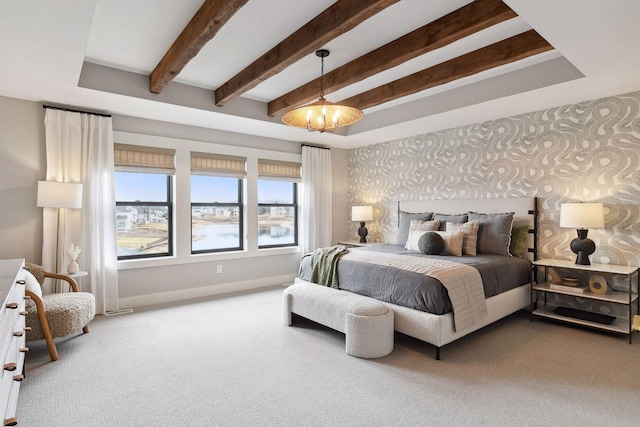 bedroom featuring a chandelier, carpet, and beamed ceiling