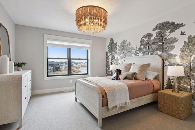 bedroom with light colored carpet and a chandelier