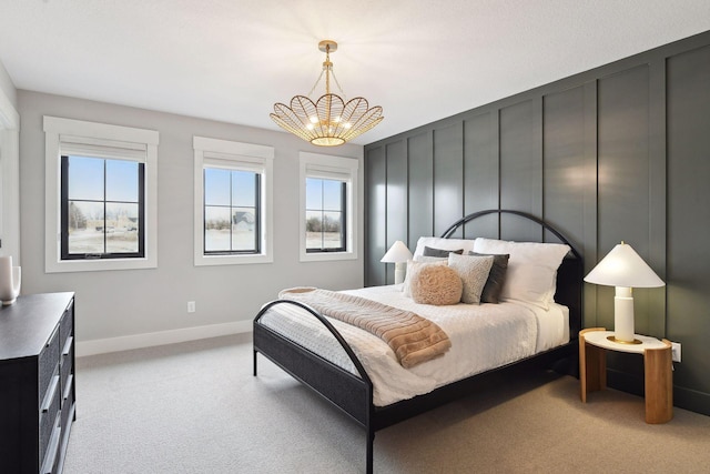 bedroom featuring light carpet and an inviting chandelier