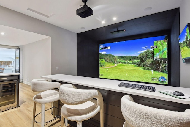 interior space featuring wine cooler, golf simulator, and light wood-type flooring