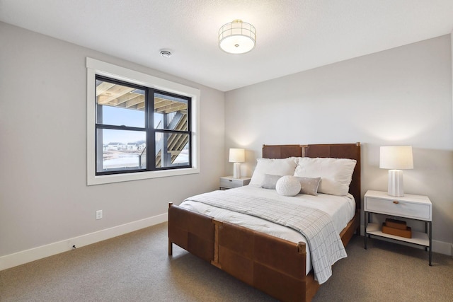 carpeted bedroom featuring a textured ceiling