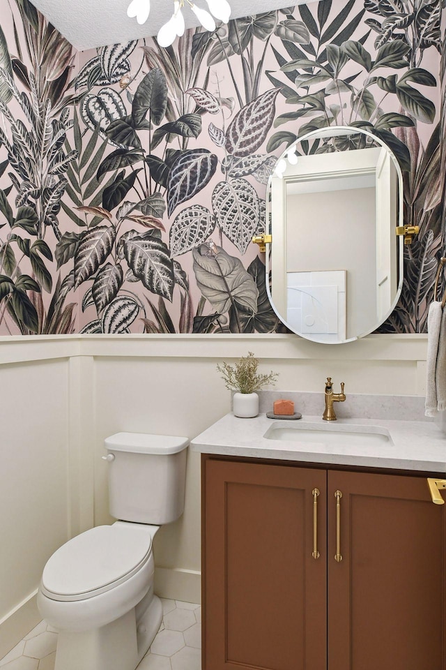 bathroom featuring tile patterned floors, vanity, and toilet