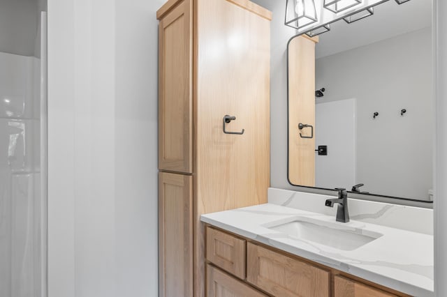 bathroom featuring vanity and a shower