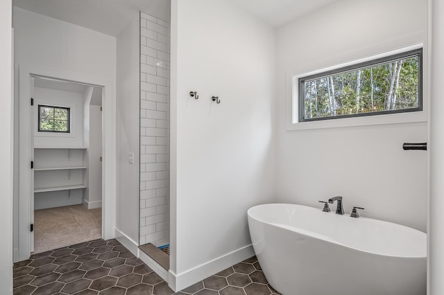 bathroom featuring tile patterned flooring and plus walk in shower