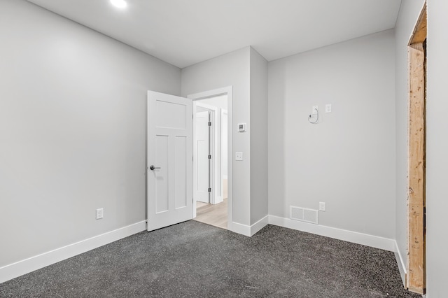 unfurnished bedroom with dark colored carpet