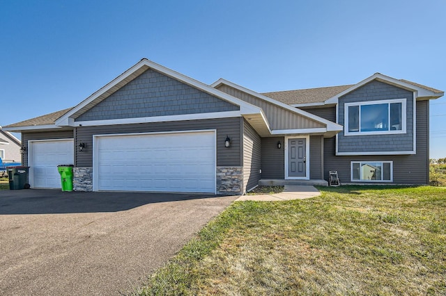 view of front of property with a front yard and a garage