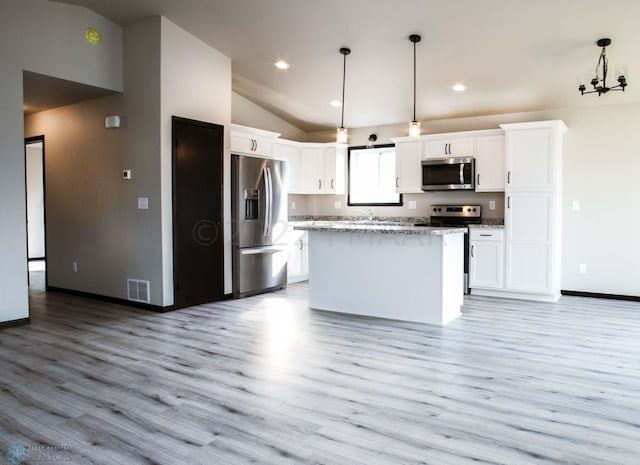 kitchen with white cabinetry, light hardwood / wood-style flooring, a center island, and appliances with stainless steel finishes