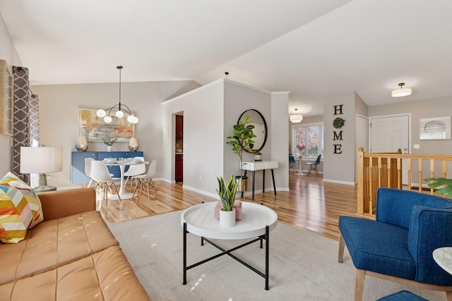 living room with vaulted ceiling, baseboards, a notable chandelier, and wood finished floors