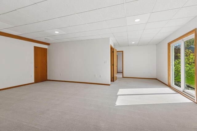 unfurnished room featuring baseboards, light carpet, and recessed lighting