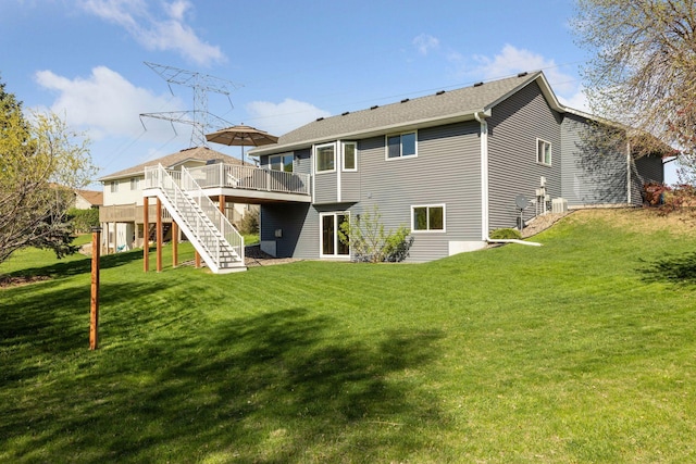 back of house featuring a yard, stairway, and a wooden deck