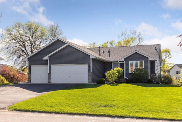 ranch-style home featuring a shingled roof, a garage, a front yard, and aphalt driveway