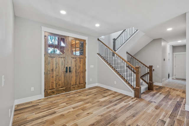 foyer entrance with light hardwood / wood-style flooring