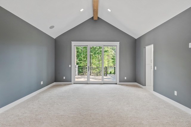 carpeted empty room featuring beam ceiling and high vaulted ceiling