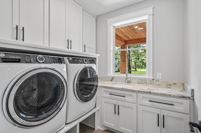 laundry area with cabinets, separate washer and dryer, sink, and wood ceiling