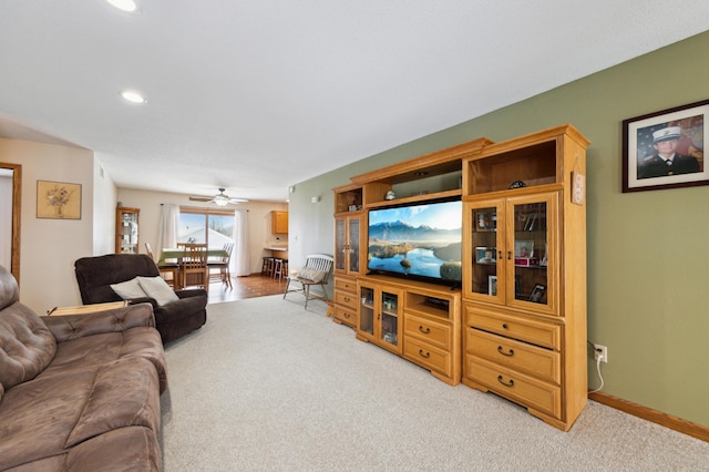 living room with ceiling fan and light colored carpet