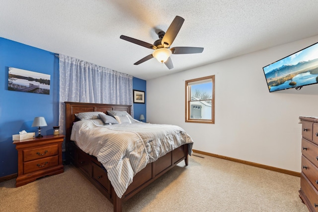 bedroom featuring a textured ceiling, ceiling fan, and light carpet