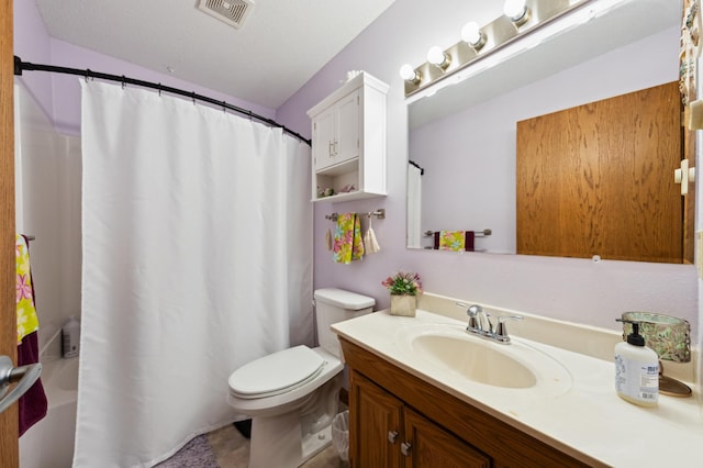 bathroom featuring toilet, vanity, and a shower with shower curtain