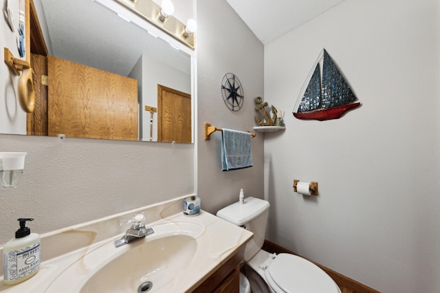 bathroom featuring toilet and vanity