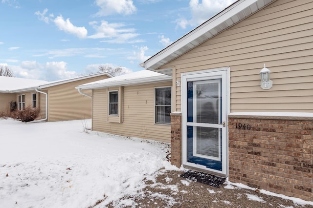 view of snow covered property entrance