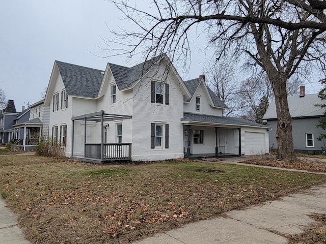 view of front of house featuring a pergola, a front yard, and a garage