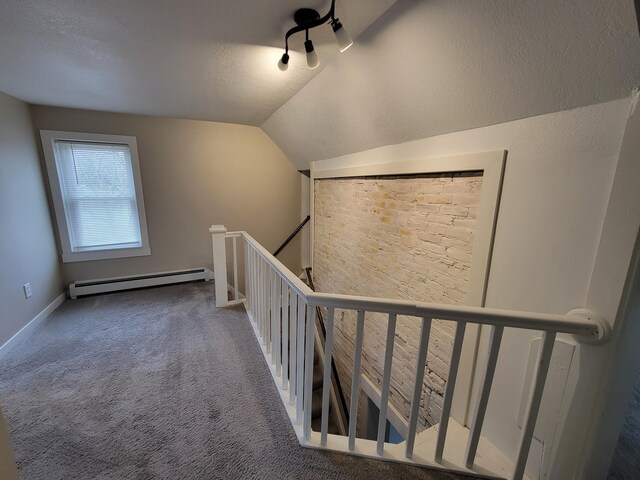 bonus room with lofted ceiling, carpet floors, a textured ceiling, and a baseboard radiator