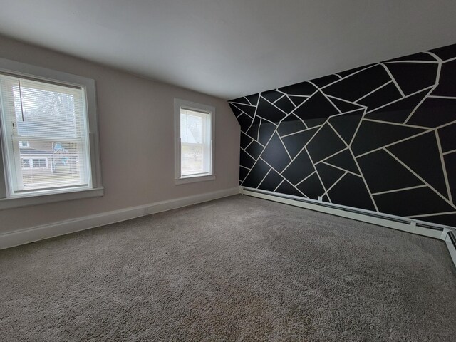 spare room featuring plenty of natural light and carpet floors