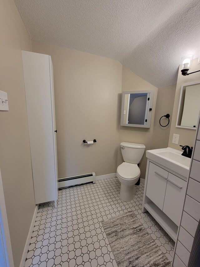 bathroom featuring vanity, toilet, a textured ceiling, and a baseboard heating unit