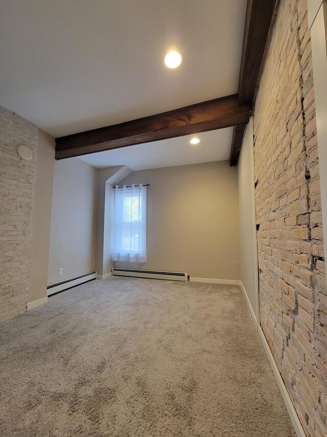 spare room featuring carpet, beam ceiling, and a baseboard radiator