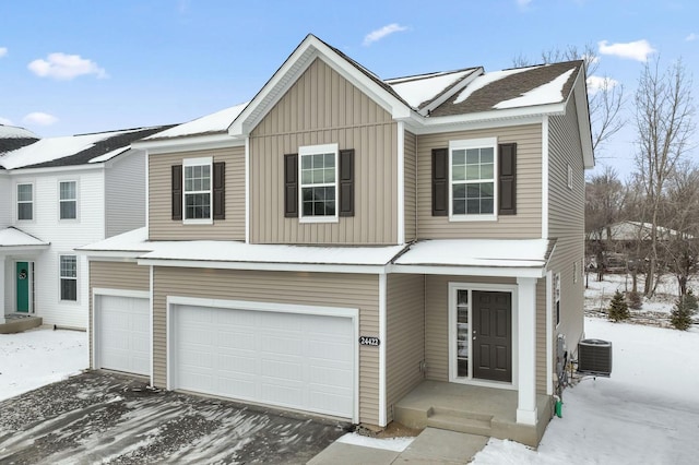 view of front of house featuring a garage and central air condition unit