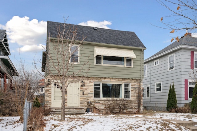 view of snow covered rear of property