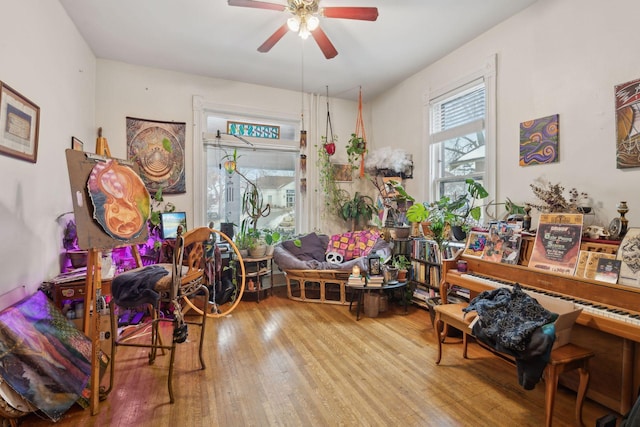 misc room with wood-type flooring and ceiling fan