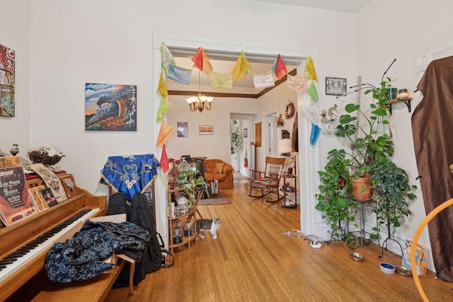 miscellaneous room featuring hardwood / wood-style floors and a notable chandelier