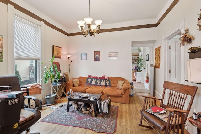 living room with an inviting chandelier and light hardwood / wood-style floors