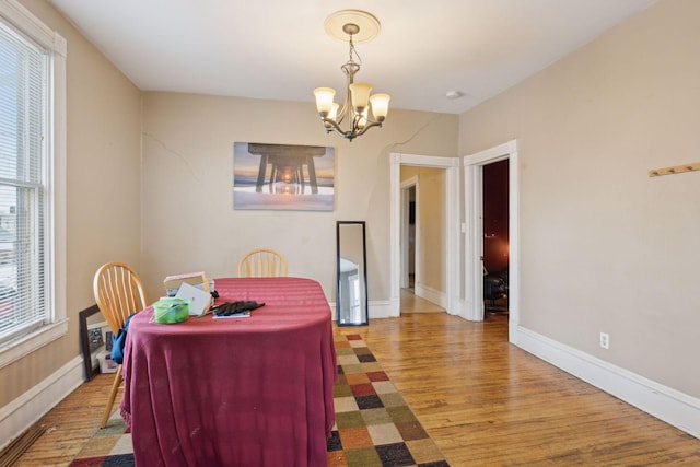 dining space featuring a notable chandelier and hardwood / wood-style floors