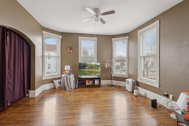 interior space with ceiling fan and wood-type flooring