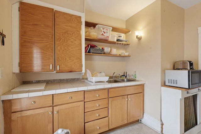 kitchen featuring sink and tile countertops