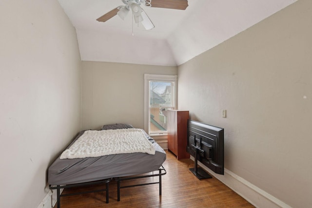 bedroom featuring ceiling fan, lofted ceiling, and hardwood / wood-style floors