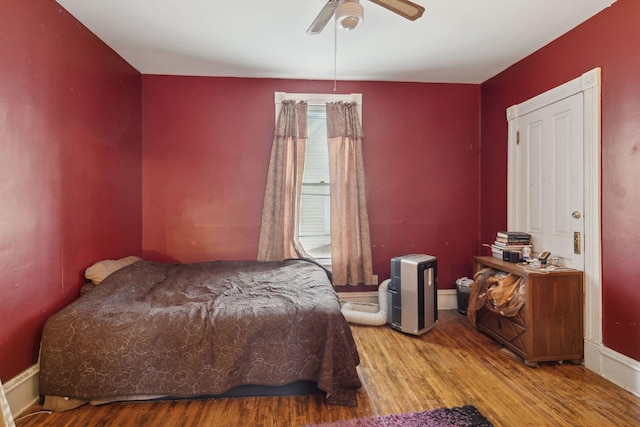 bedroom with ceiling fan and light wood-type flooring