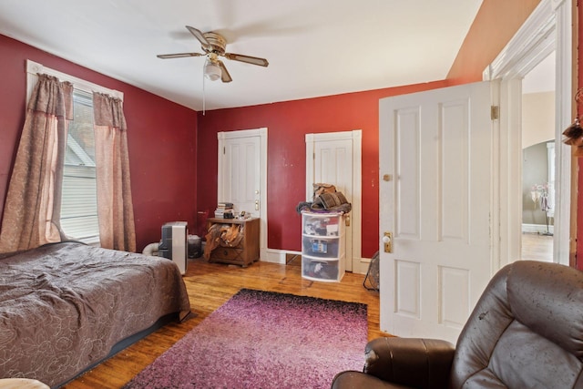 bedroom with ceiling fan and wood-type flooring