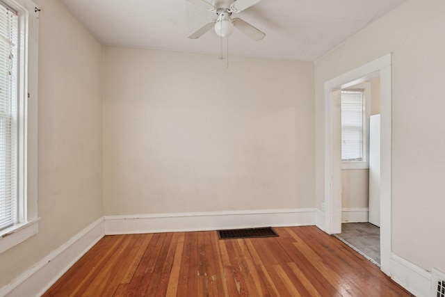 unfurnished room with ceiling fan and hardwood / wood-style floors