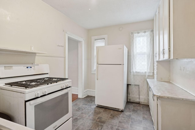 kitchen with white cabinetry and white appliances